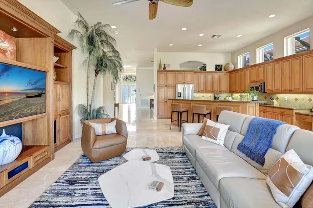 a living room with furniture and a potted plant