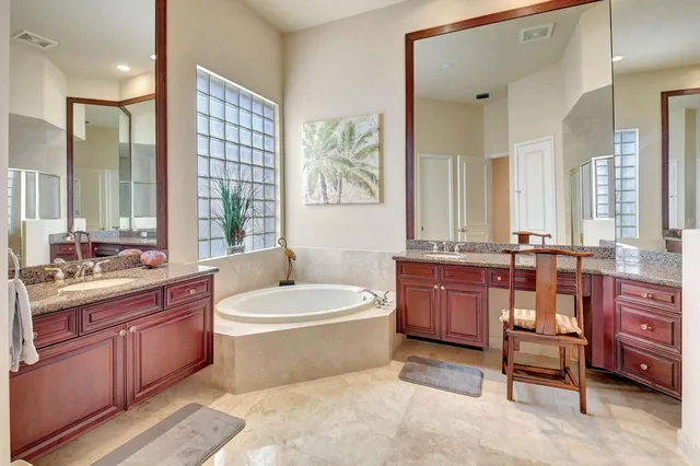 a view of walk in closet with window and bathroom