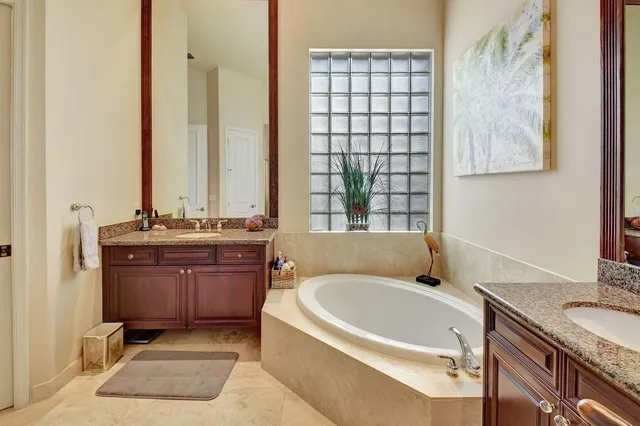 a view of a patio with a table and chairs under an umbrella