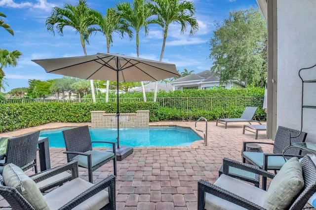 a swimming pool with outdoor seating and yard
