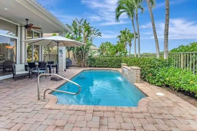 a view of house with swimming pool and sitting area