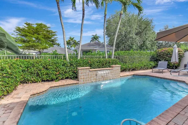 a dining room with furniture a chandelier and wooden floor