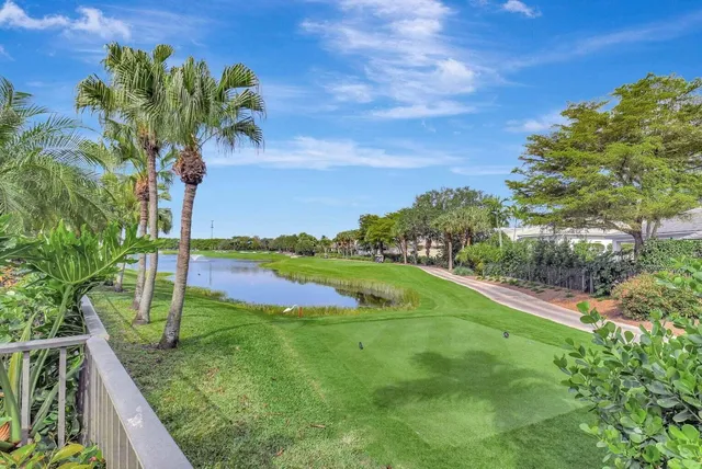 a view of a patio with dining table and chairs with wooden floor
