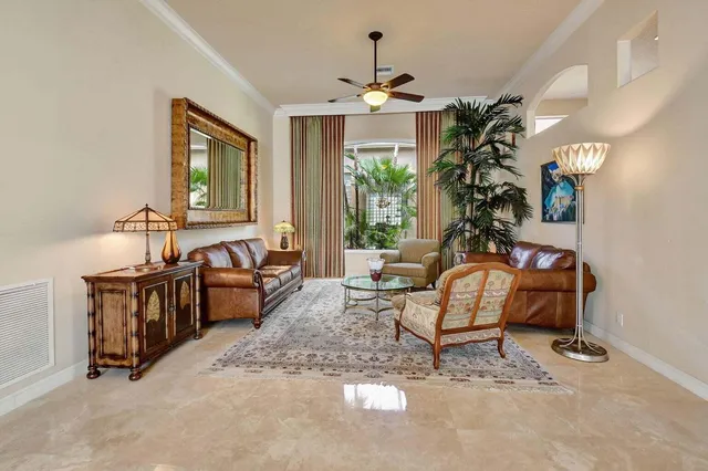 a dining room with furniture a chandelier and window
