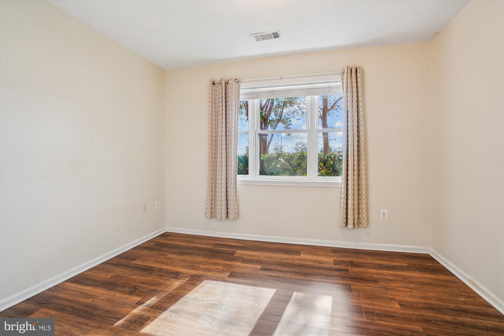 9490 Virginia Center Boulevard, Unit 130 Vienna, VA 22181 - Photo 18 of 57 a view of empty room with wooden floor and fan