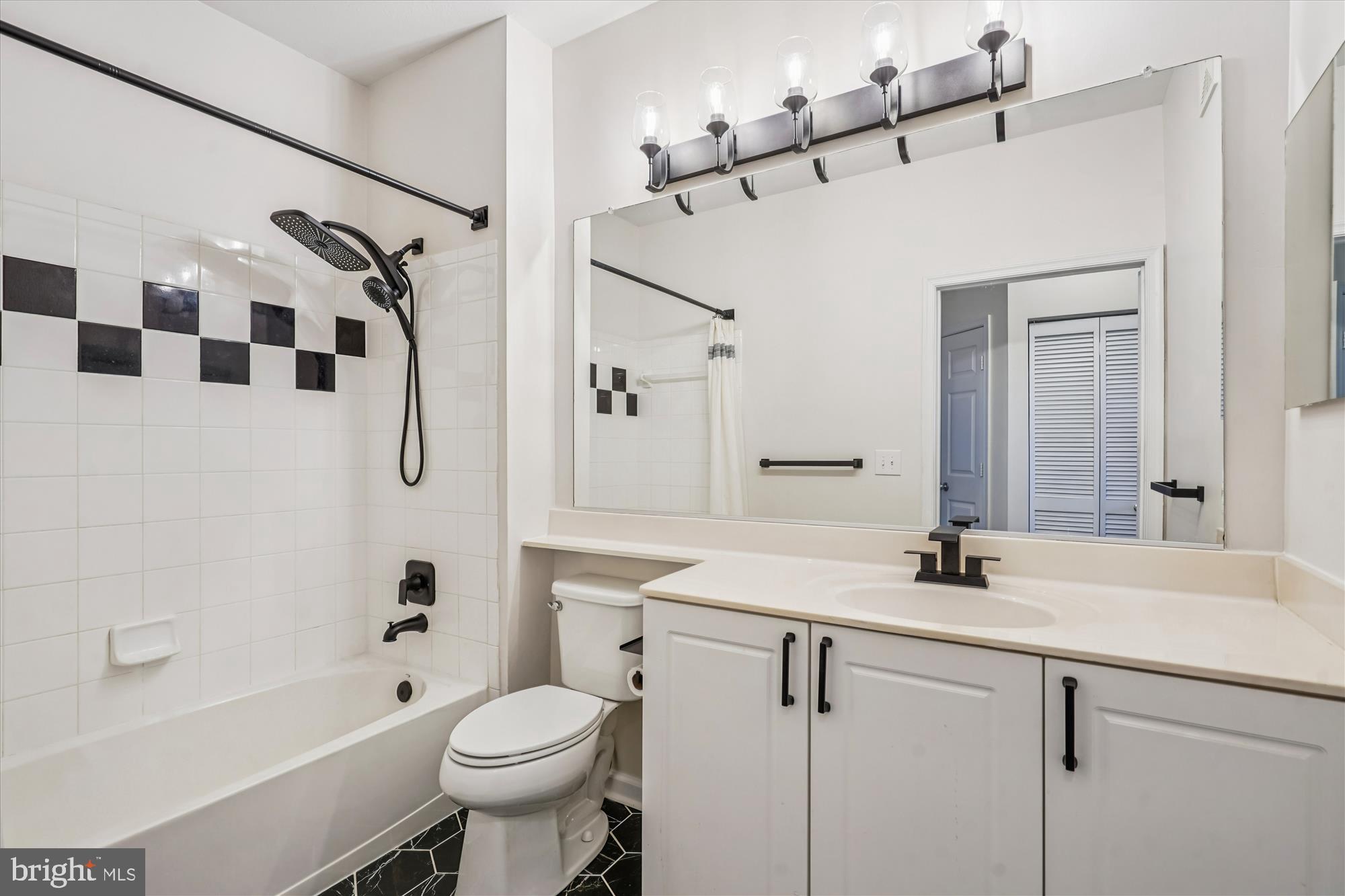 9490 Virginia Center Boulevard, Unit 130 Vienna, VA 22181 - Photo 22 of 57 a bathroom with a sink toilet and shower