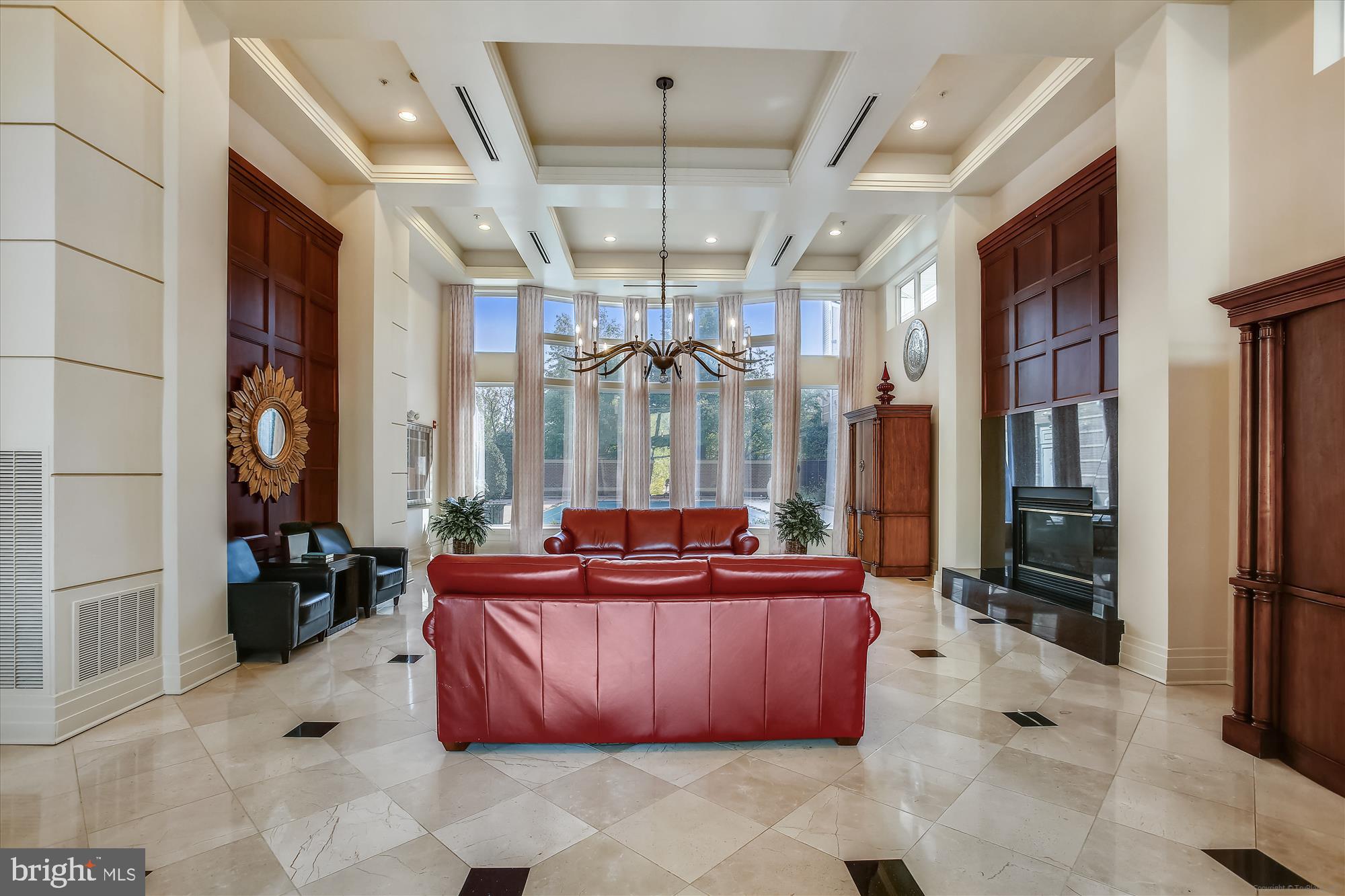 9490 Virginia Center Boulevard, Unit 130 Vienna, VA 22181 - Photo 36 of 57 a living room with furniture a chandelier and a large window