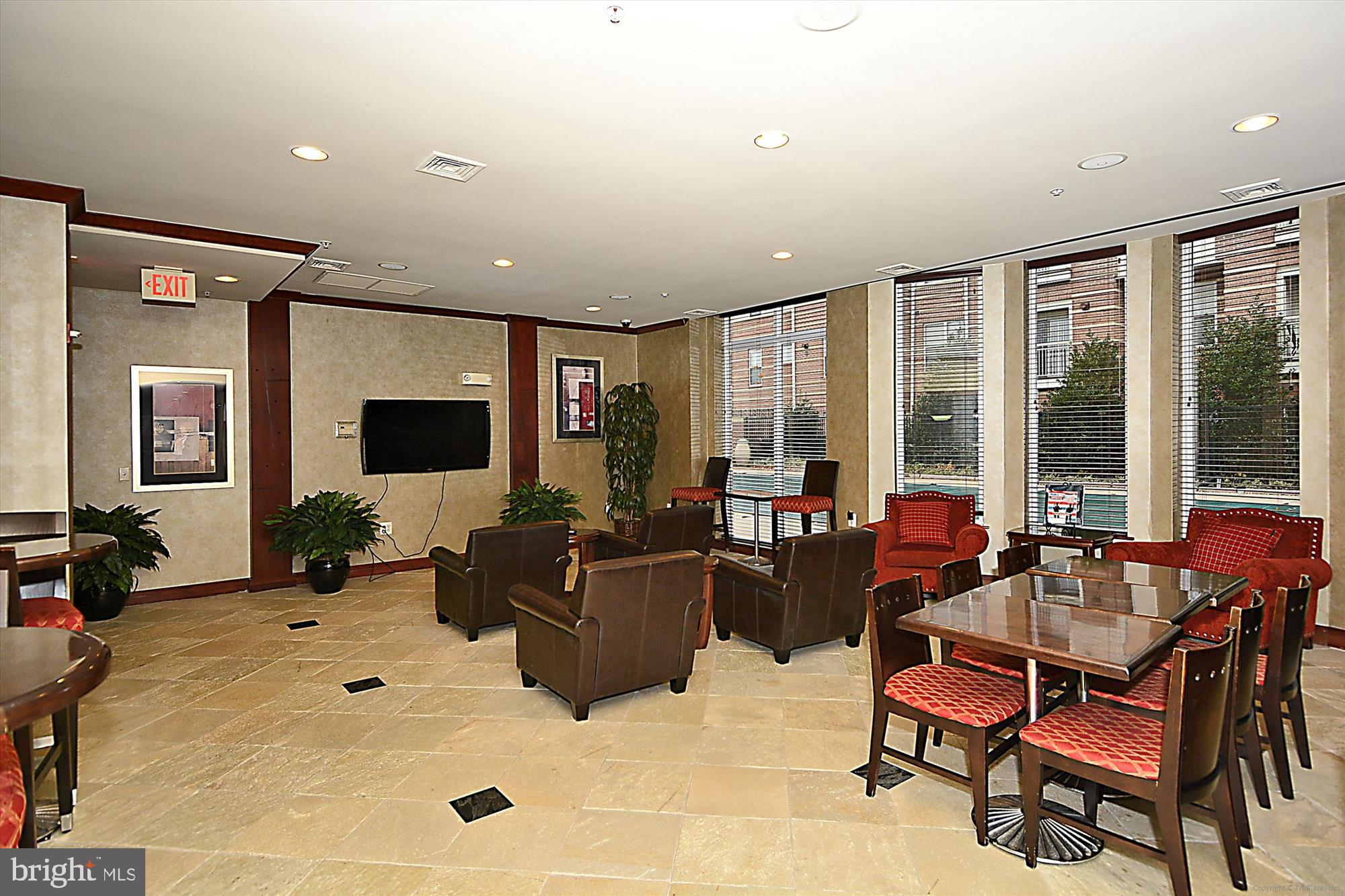 9490 Virginia Center Boulevard, Unit 130 Vienna, VA 22181 - Photo 44 of 57 a living room with furniture and a flat screen tv