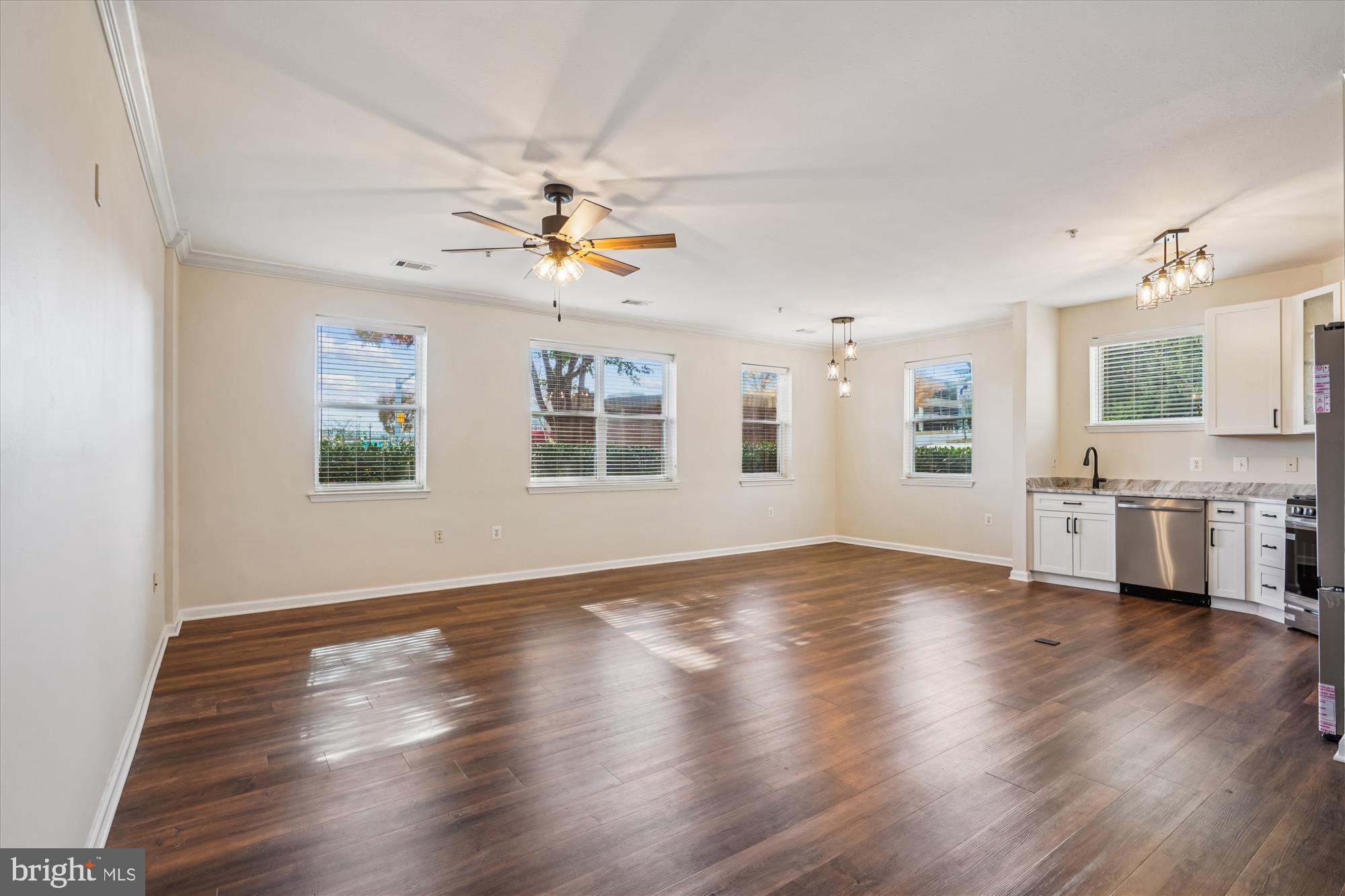 9490 Virginia Center Boulevard, Unit 130 Vienna, VA 22181 - Photo 5 of 57 a view of an empty room with a window and wooden floor