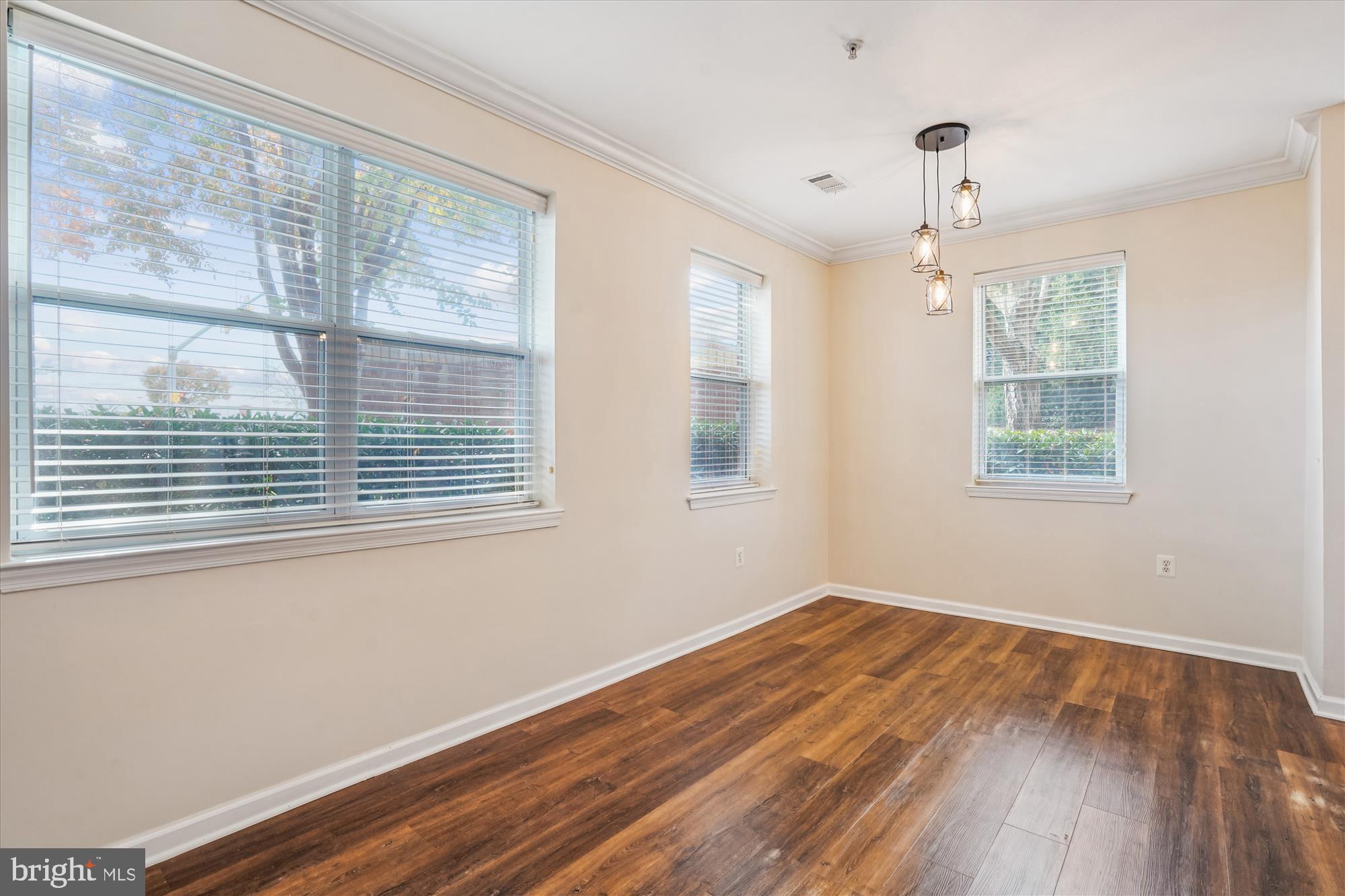 9490 Virginia Center Boulevard, Unit 130 Vienna, VA 22181 - Photo 6 of 57 a view of empty room with wooden floor and fan