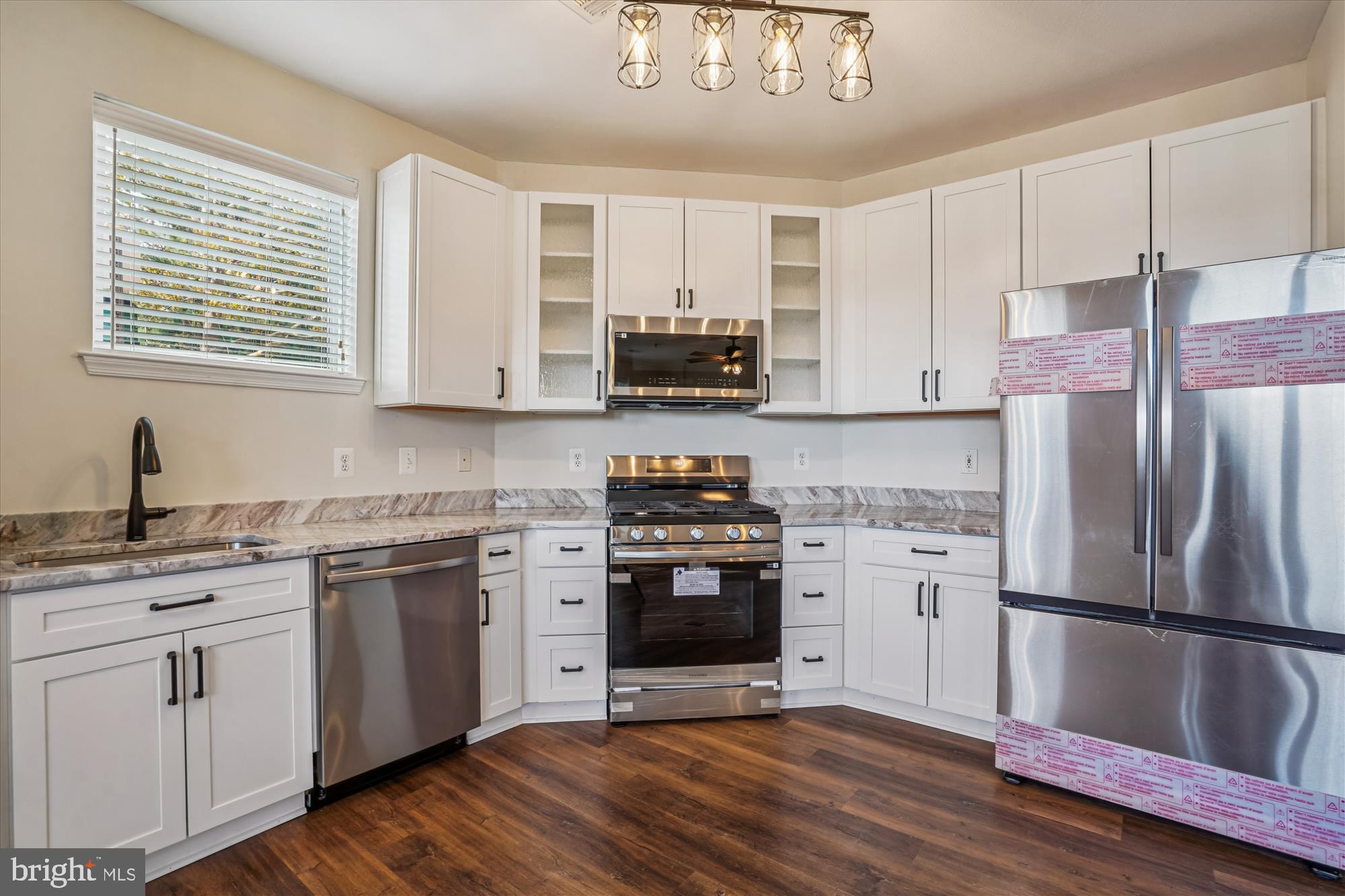 9490 Virginia Center Boulevard, Unit 130 Vienna, VA 22181 - Photo 9 of 57 a kitchen with stainless steel appliances granite countertop a stove a sink dishwasher a refrigerator and a stove