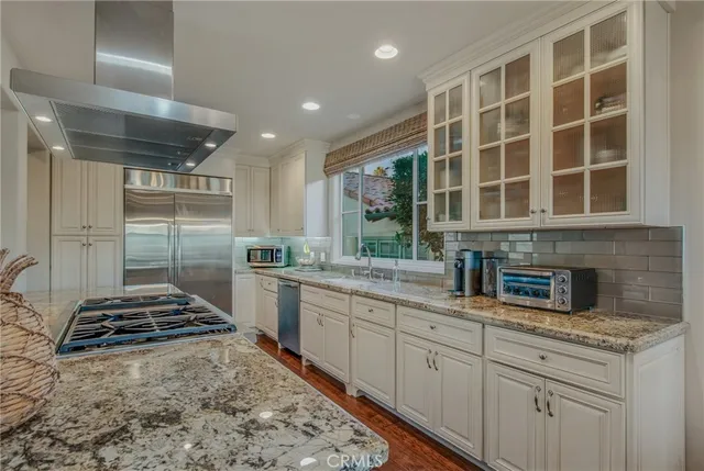 a kitchen with stainless steel appliances granite countertop a stove and a sink