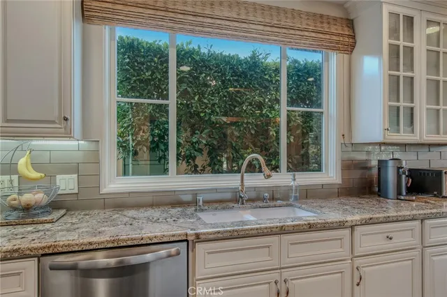 a kitchen with granite countertop a sink and a window