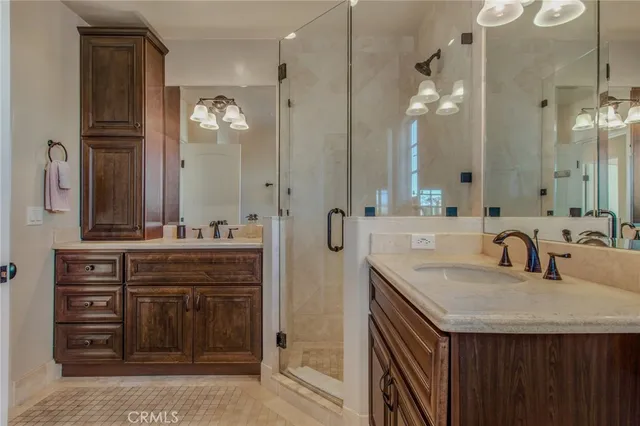 a bathroom has pair of shower