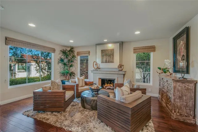 a living room with furniture fireplace and window
