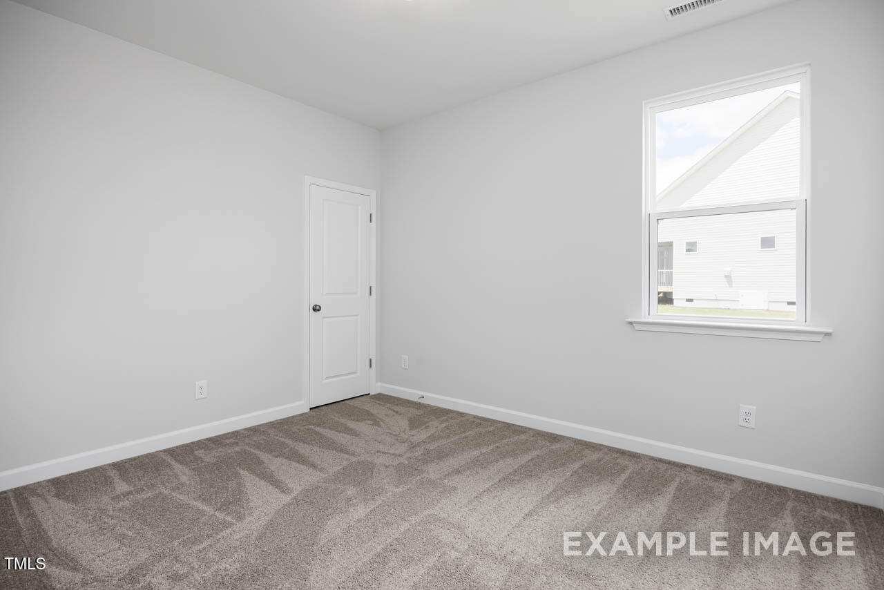 271 Crop Road Angier, NC 27501 - Photo 11 of 28 an empty room with a window