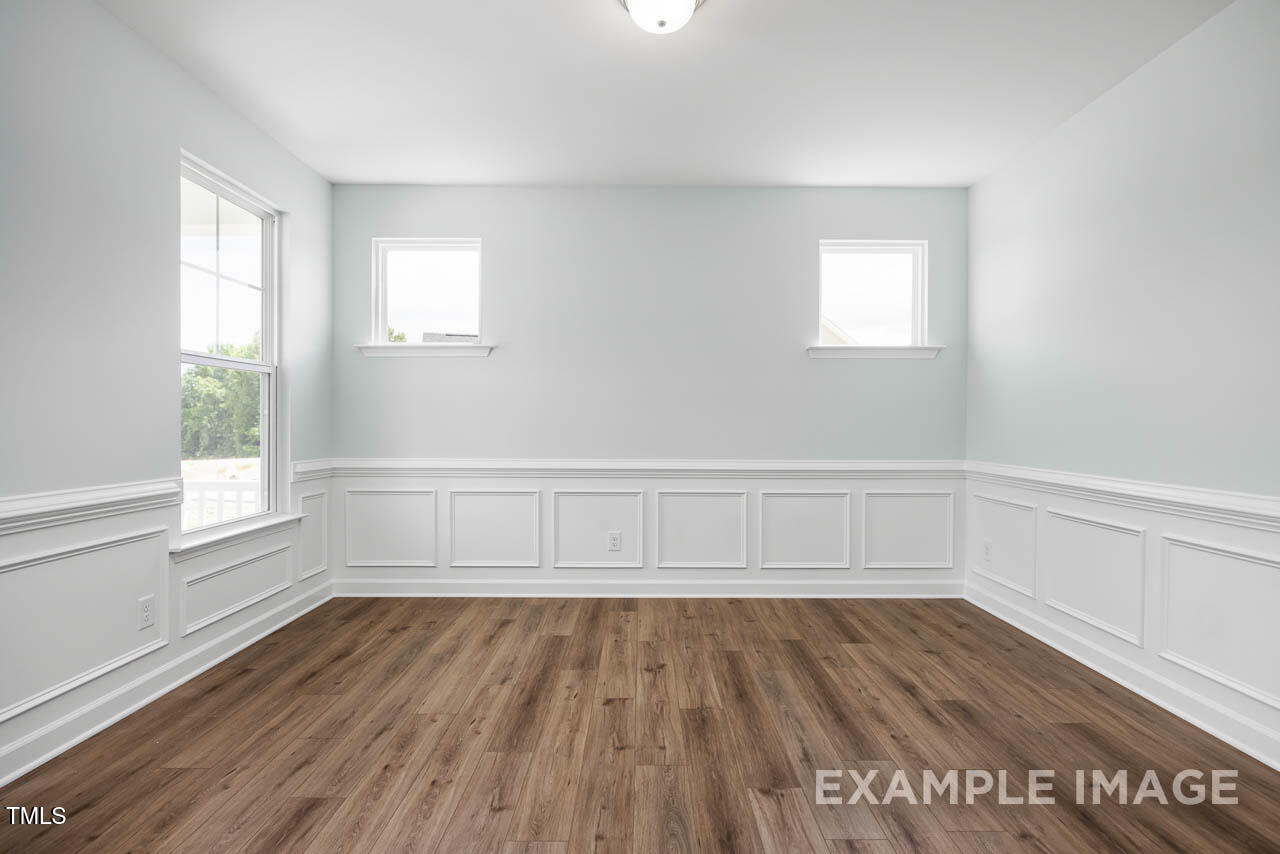 271 Crop Road Angier, NC 27501 - Photo 4 of 28 a view of an empty room with wooden floor and a window