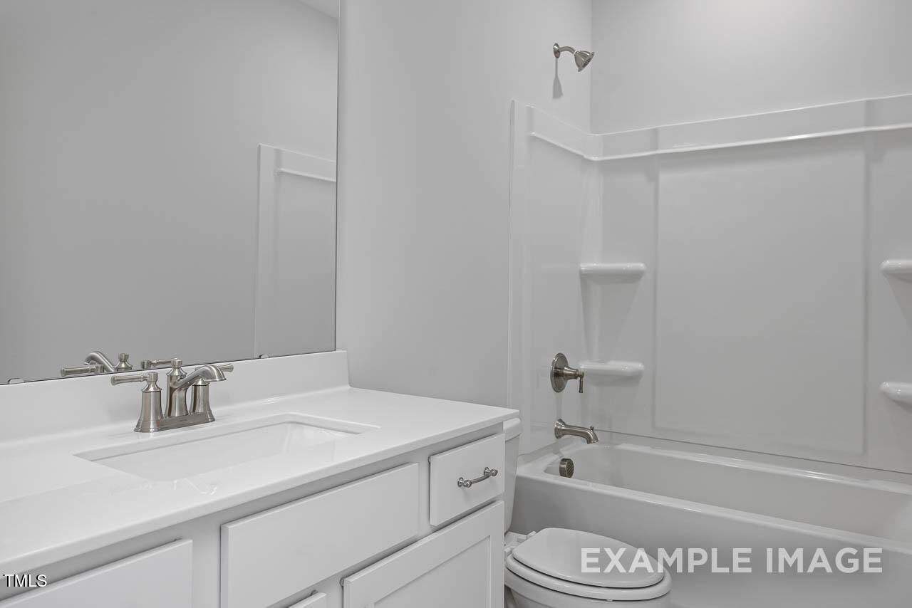 271 Crop Road Angier, NC 27501 - Photo 10 of 28 a bathroom with a granite countertop sink toilet and bathtub
