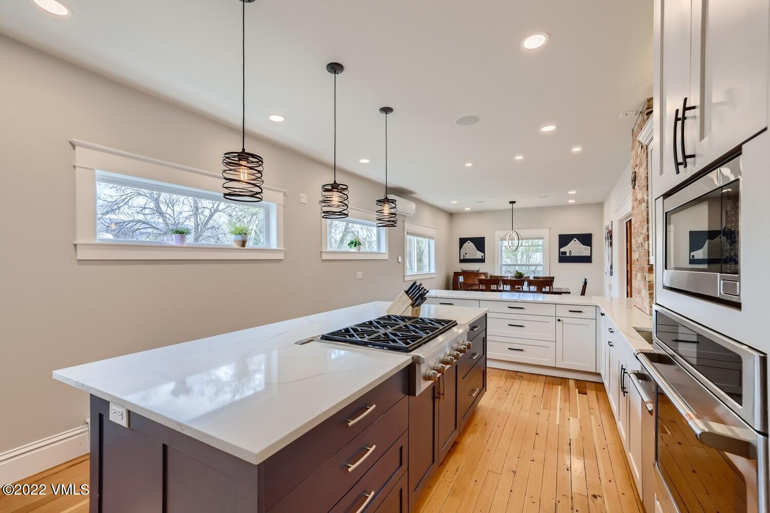 306 Howard Street Eagle, CO 81631 - Photo 11 of 30 a kitchen with stainless steel appliances granite countertop a sink stove and refrigerator