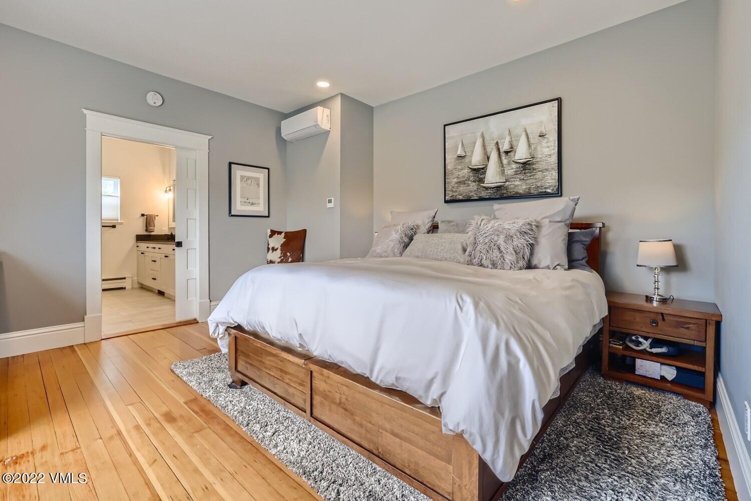 306 Howard Street Eagle, CO 81631 - Photo 13 of 30 a spacious bedroom with a bed and a painting on the wall
