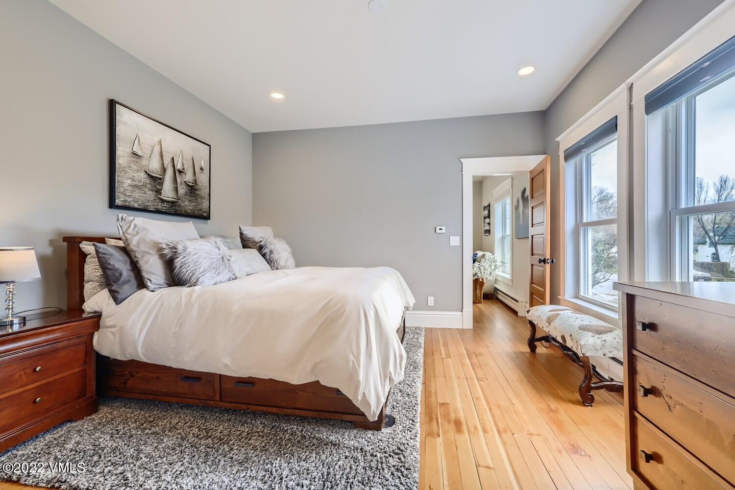 306 Howard Street Eagle, CO 81631 - Photo 14 of 30 a bedroom with a bed and wooden floor