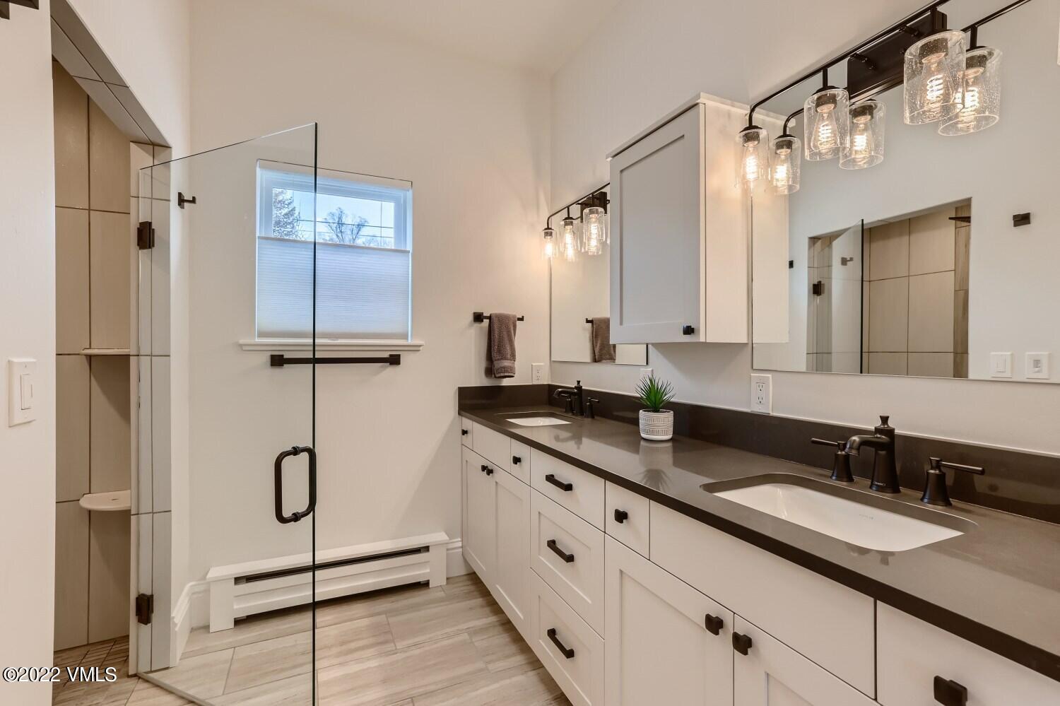 306 Howard Street Eagle, CO 81631 - Photo 15 of 30 a bathroom with double vanity and a shower