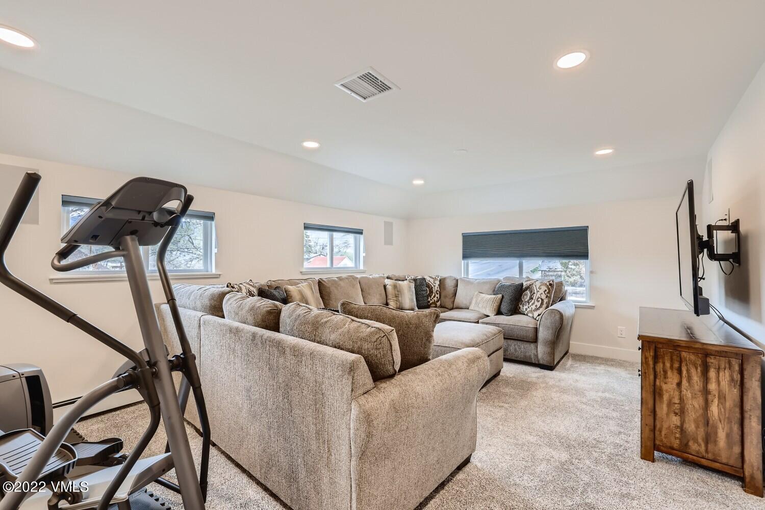 306 Howard Street Eagle, CO 81631 - Photo 17 of 30 a living room with furniture a flat screen tv and a window