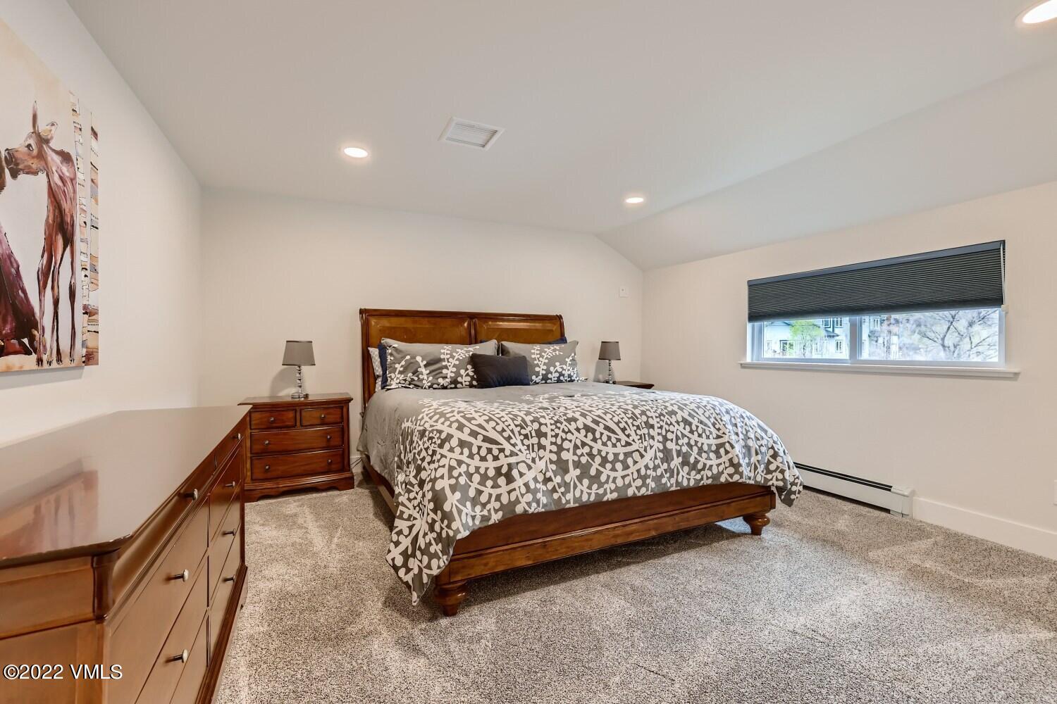 306 Howard Street Eagle, CO 81631 - Photo 20 of 30 a bedroom with a bed and wooden floor