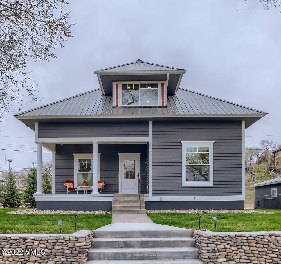 306 Howard Street Eagle, CO 81631 - Photo 2 of 30 a front view of a house with a yard and potted plants
