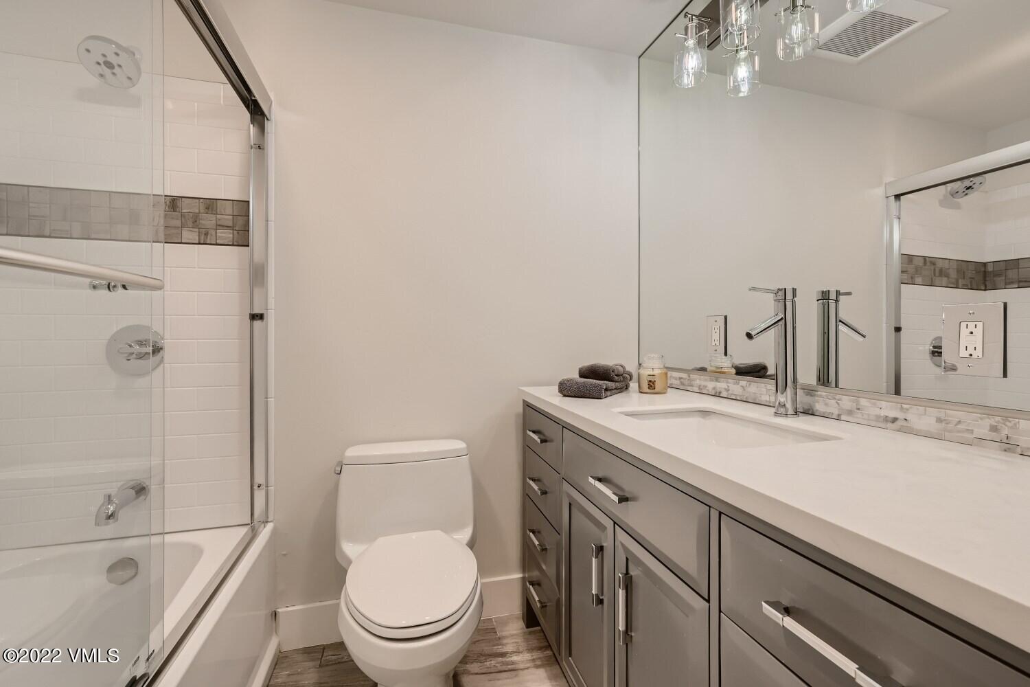 306 Howard Street Eagle, CO 81631 - Photo 21 of 30 a bathroom with a granite countertop sink a toilet and shower