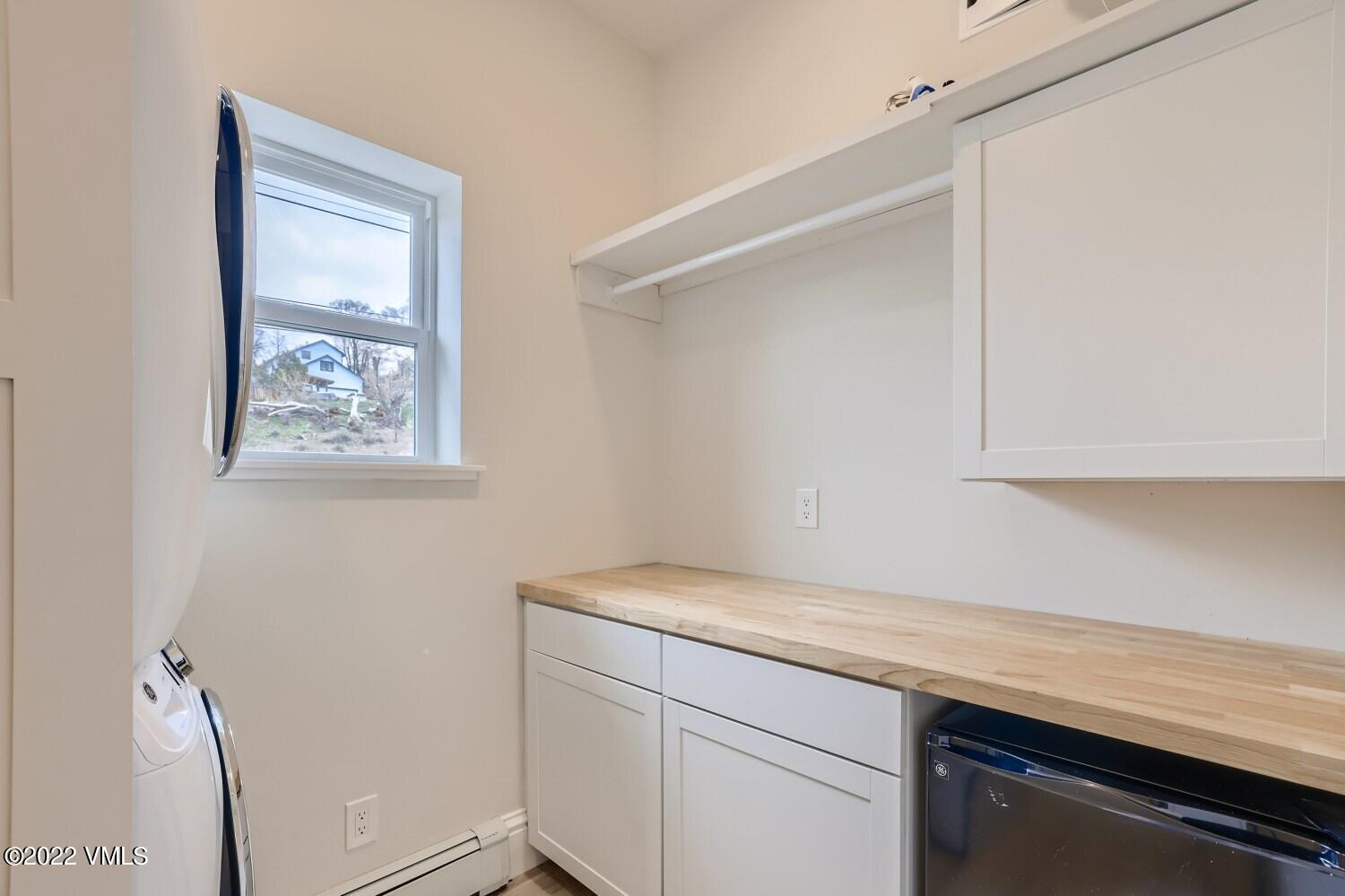 306 Howard Street Eagle, CO 81631 - Photo 26 of 30 a hallway with a microwave and cabinets
