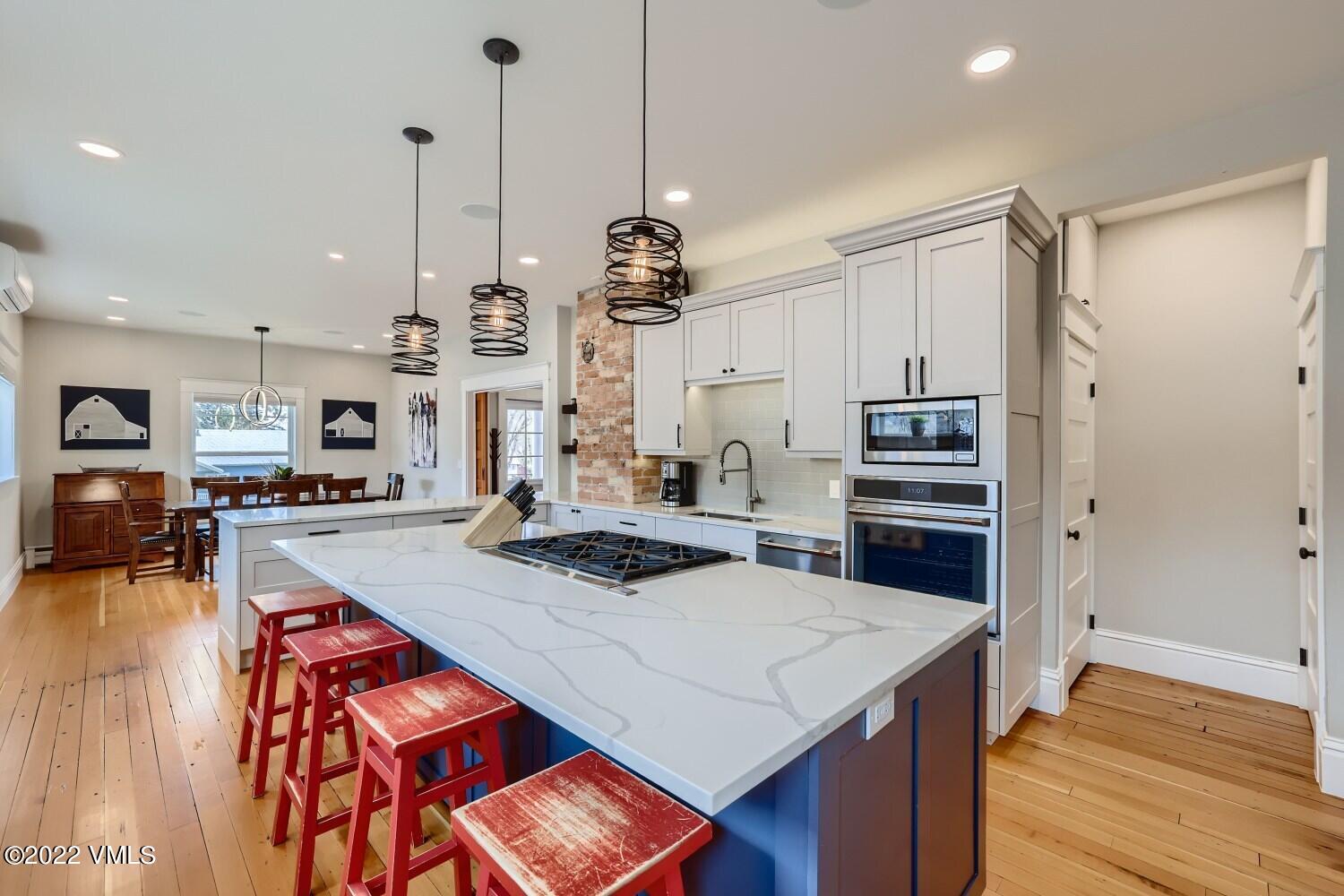 306 Howard Street Eagle, CO 81631 - Photo 10 of 30 a kitchen with stainless steel appliances granite countertop a sink a stove and a refrigerator