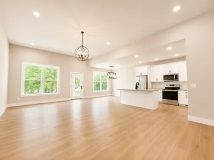 a kitchen with stainless steel appliances kitchen island granite countertop a refrigerator stove and sink