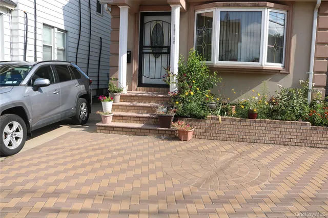 a view of a car park in front of a house