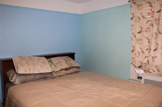 a large bed sitting in a bedroom next to a lamp