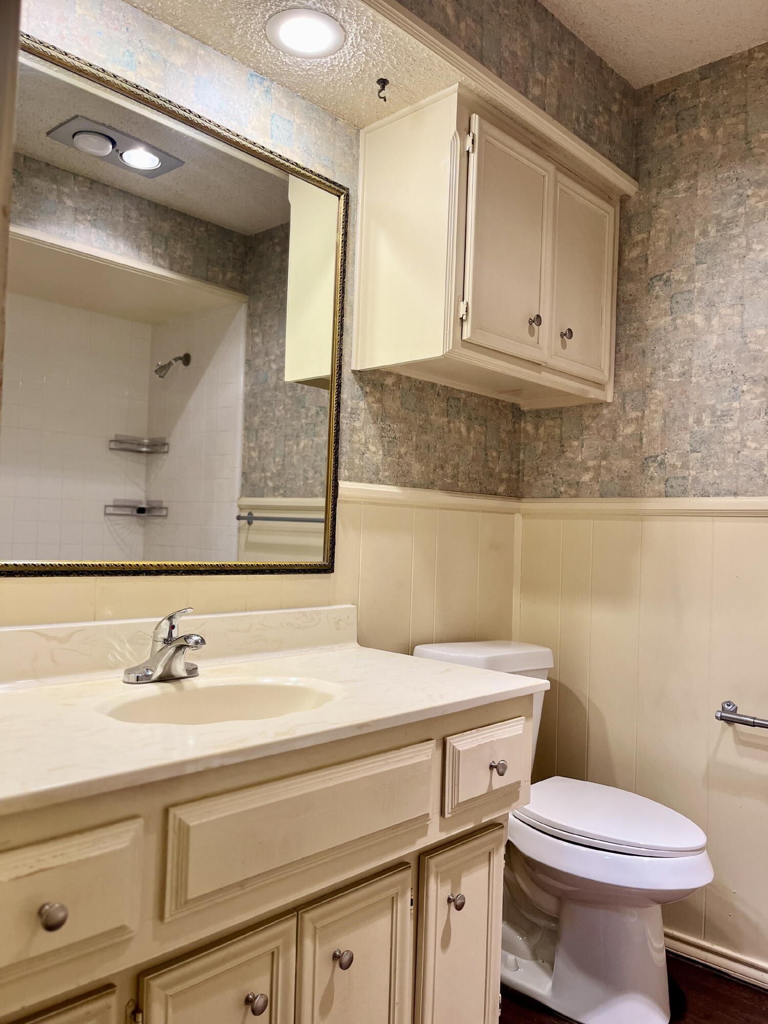 2308 74th Street, Unit A2 Lubbock, TX 79423 - Photo 12 of 16 a bathroom with a sink a toilet and mirror