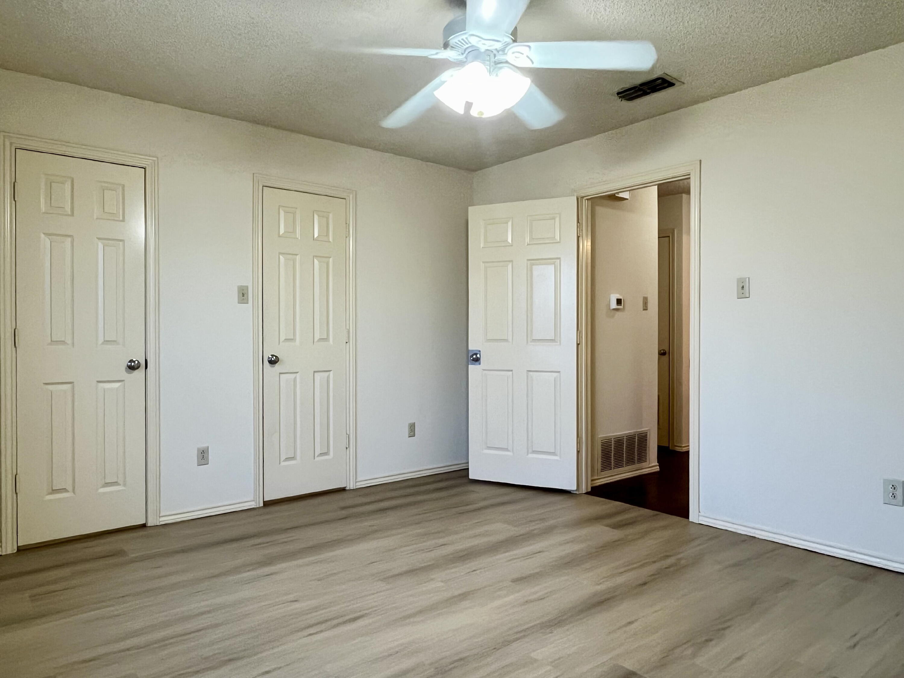 2308 74th Street, Unit A2 Lubbock, TX 79423 - Photo 13 of 16 a view of an empty room with wooden floor