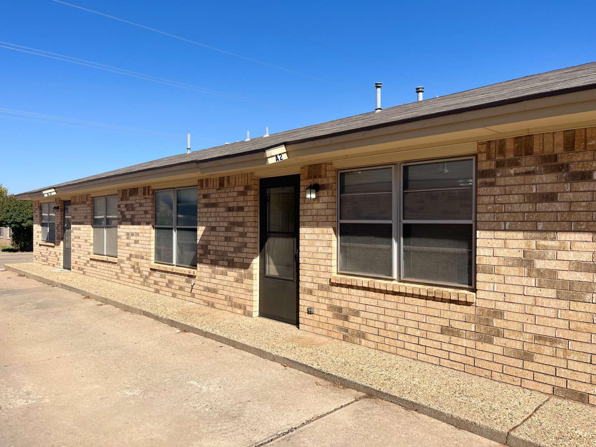 2308 74th Street, Unit A2 Lubbock, TX 79423 - Photo 2 of 16 a front view of a building with a glass door