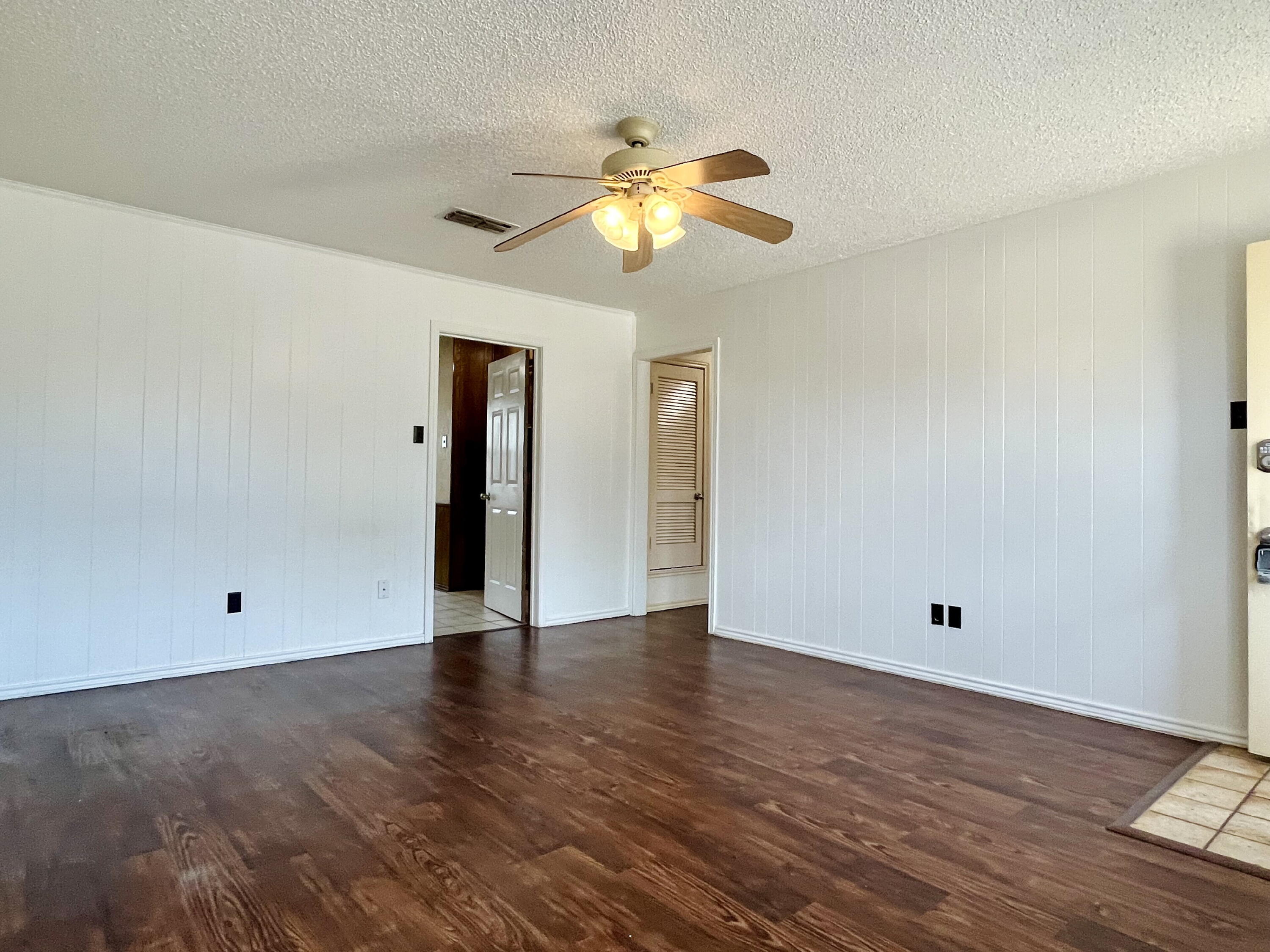 2308 74th Street, Unit A2 Lubbock, TX 79423 - Photo 3 of 16 a view of an empty room with window and wooden floor