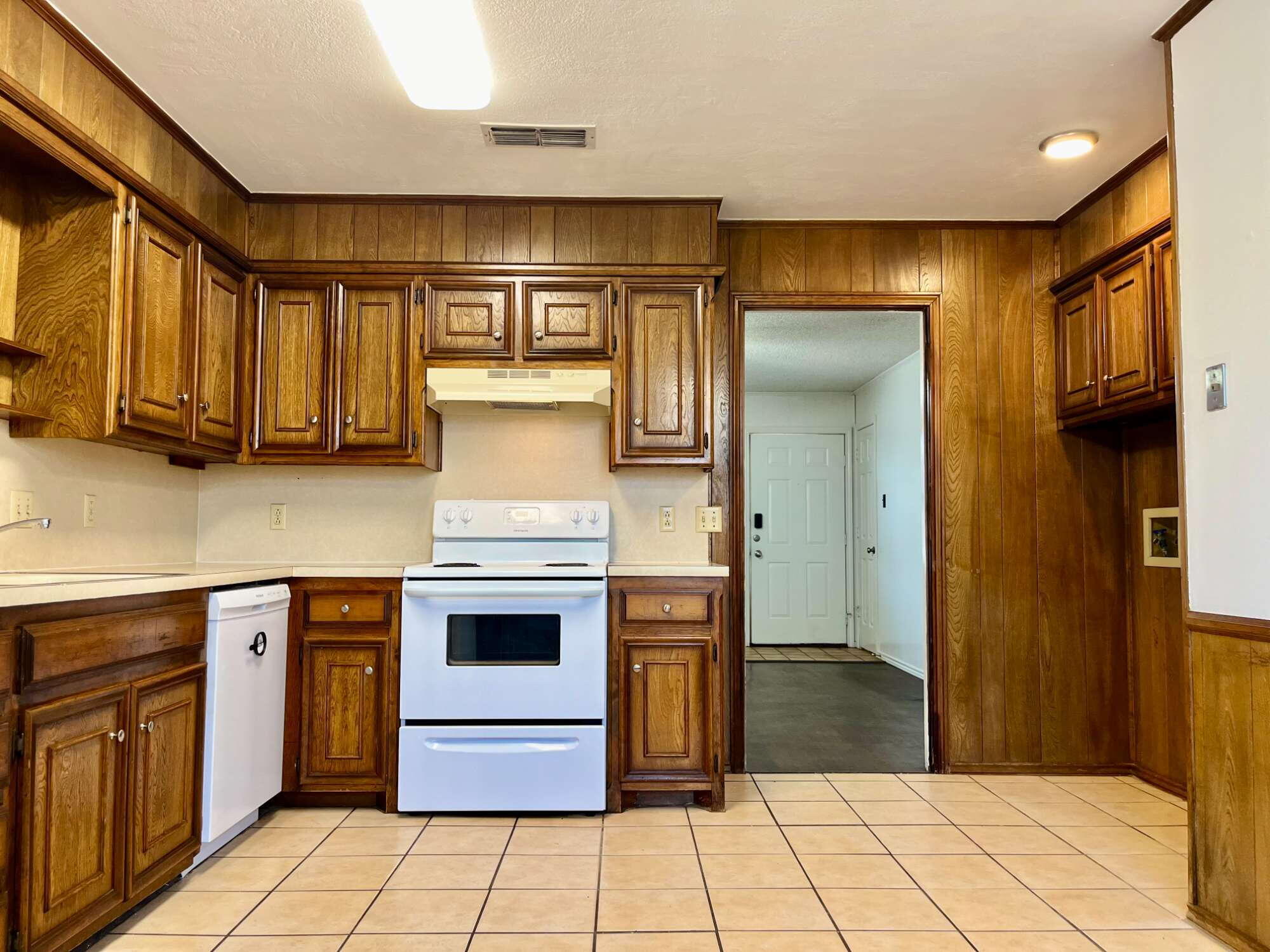 2308 74th Street, Unit A2 Lubbock, TX 79423 - Photo 6 of 16 a kitchen with stainless steel appliances granite countertop a stove a sink and a refrigerator