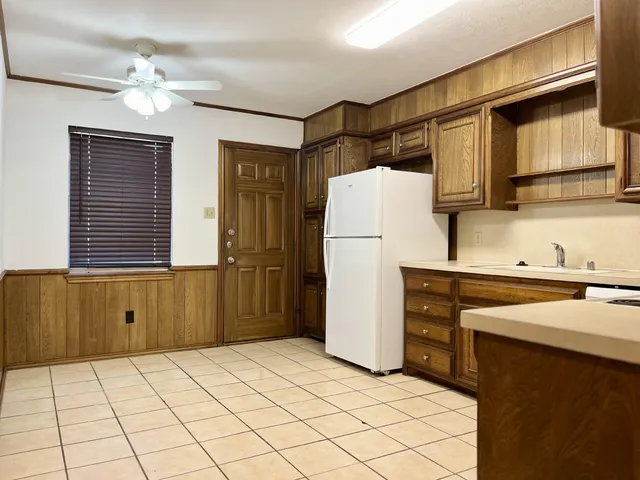 a kitchen with a refrigerator and a sink