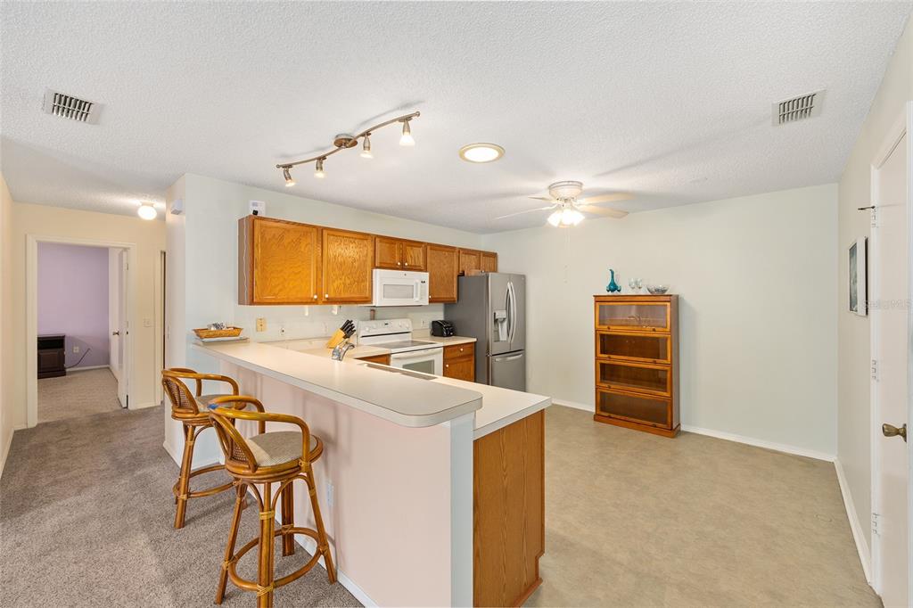 1710 Rosales Road The Villages, FL 32162 - Photo 8 of 23 a large kitchen with a table and chairs