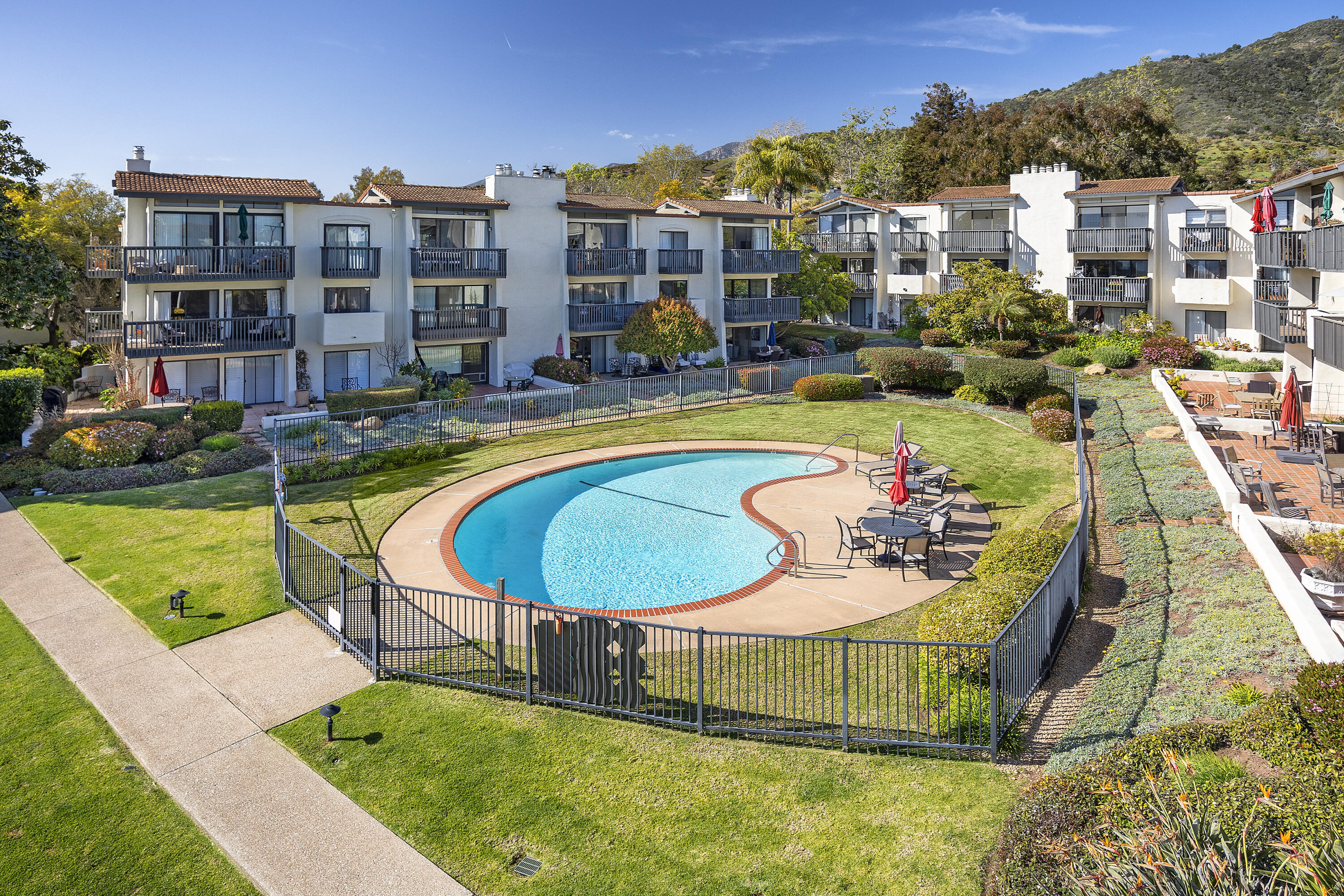 3375 Foothill Road, Unit 821 Carpinteria, CA 93013 - Photo 10 of 12 a swimming pool with outdoor seating and yard