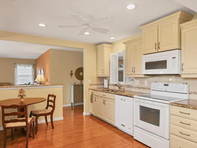 a kitchen with a sink stove and white cabinets