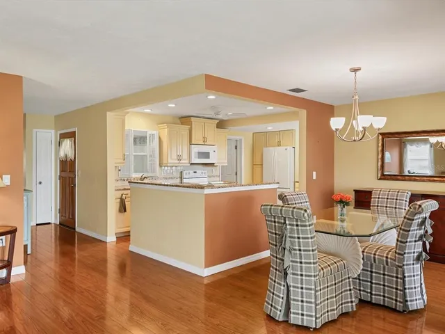 a dining room with furniture and wooden floor