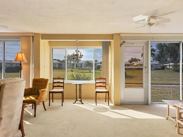 a living room with furniture and a floor to ceiling window
