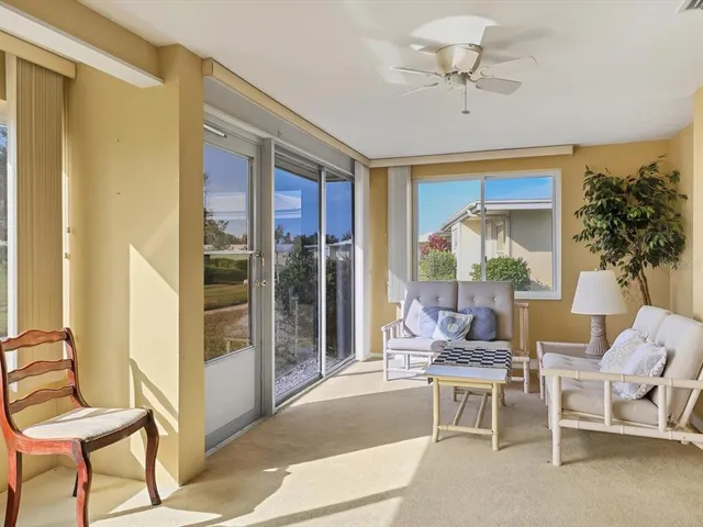a living room with furniture and a floor to ceiling window