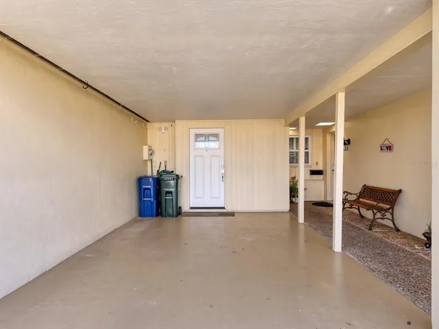 an empty room with furniture and natural light
