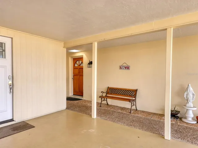 a view of a room with furniture and a ceiling fan
