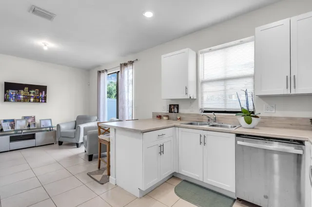 a kitchen with a sink window and cabinets